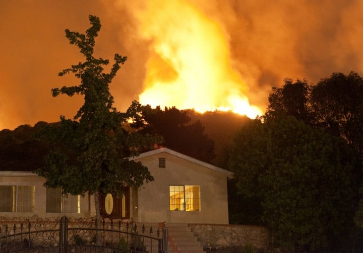 house on fire during wildfire