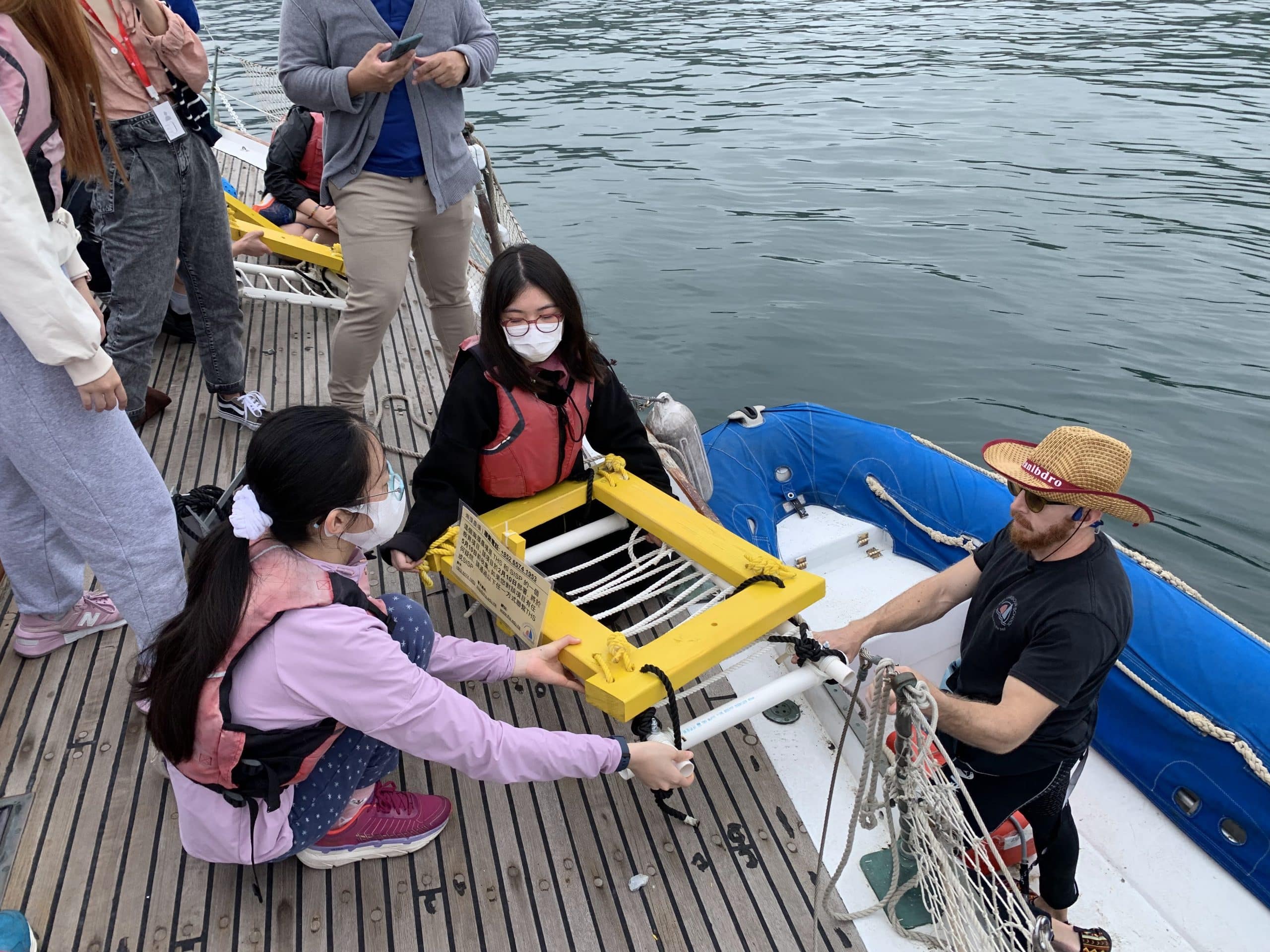 Students deploy a farm structure into the sea. Photo: Handout.