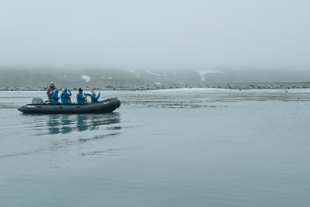 A group of tourists on a "Zodiac", a military-standard speedboat used to transport people to inhospitable areas to get a chance to observe Antarctica's wildlife up close.