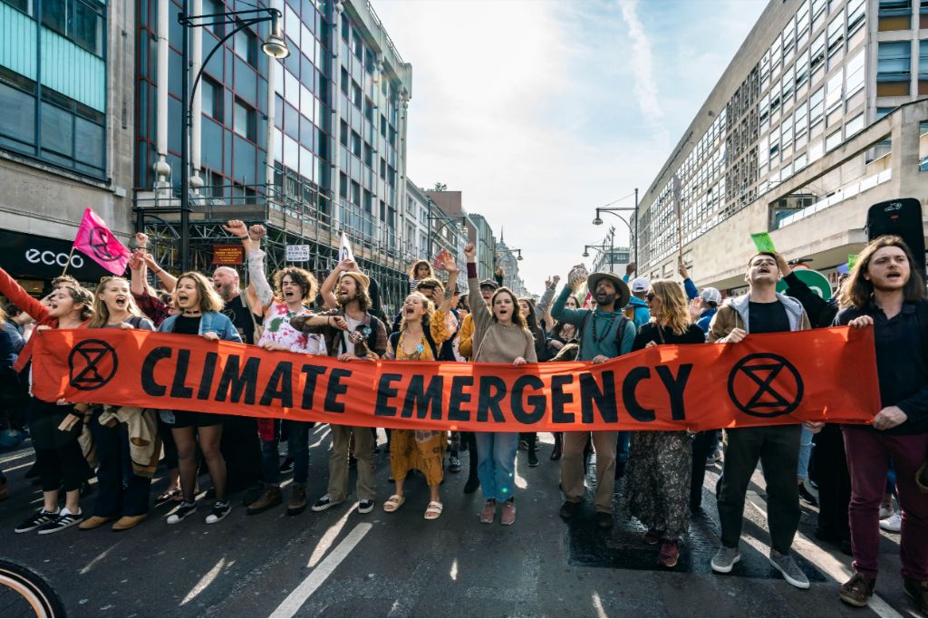 Extinction Rebellion protesters hold a sign saying "climate emergency"