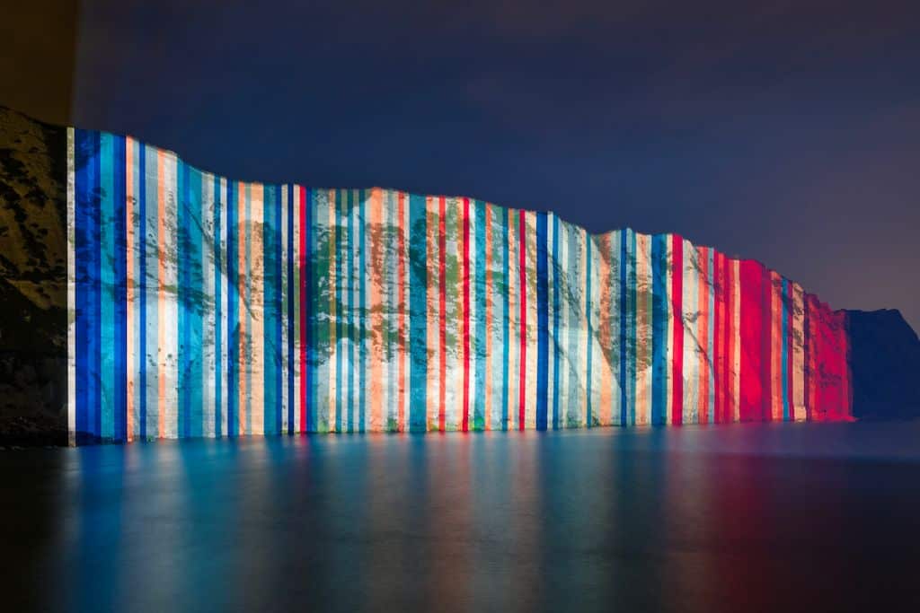 The UK warming stripes were projected onto the White Cliffs of Dover in June 2023 to mark Show Your Stripes day.