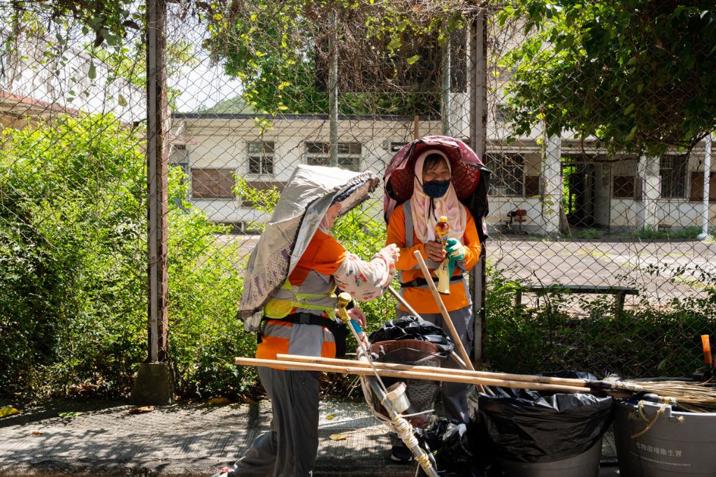 Cleaners share handmade lemon tea while working in the New Territories, Hong Kong.